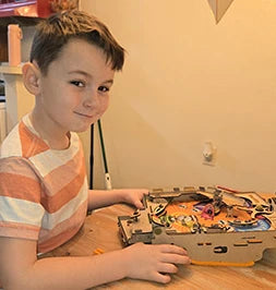 Boy playing his Pinball Machine build